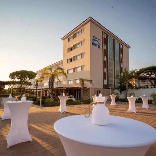 Taxi de Huelva al Hotel Pato Rojo, en Punta Umbría: la fachada del hotel al atardecer, con las mesas de la terraza